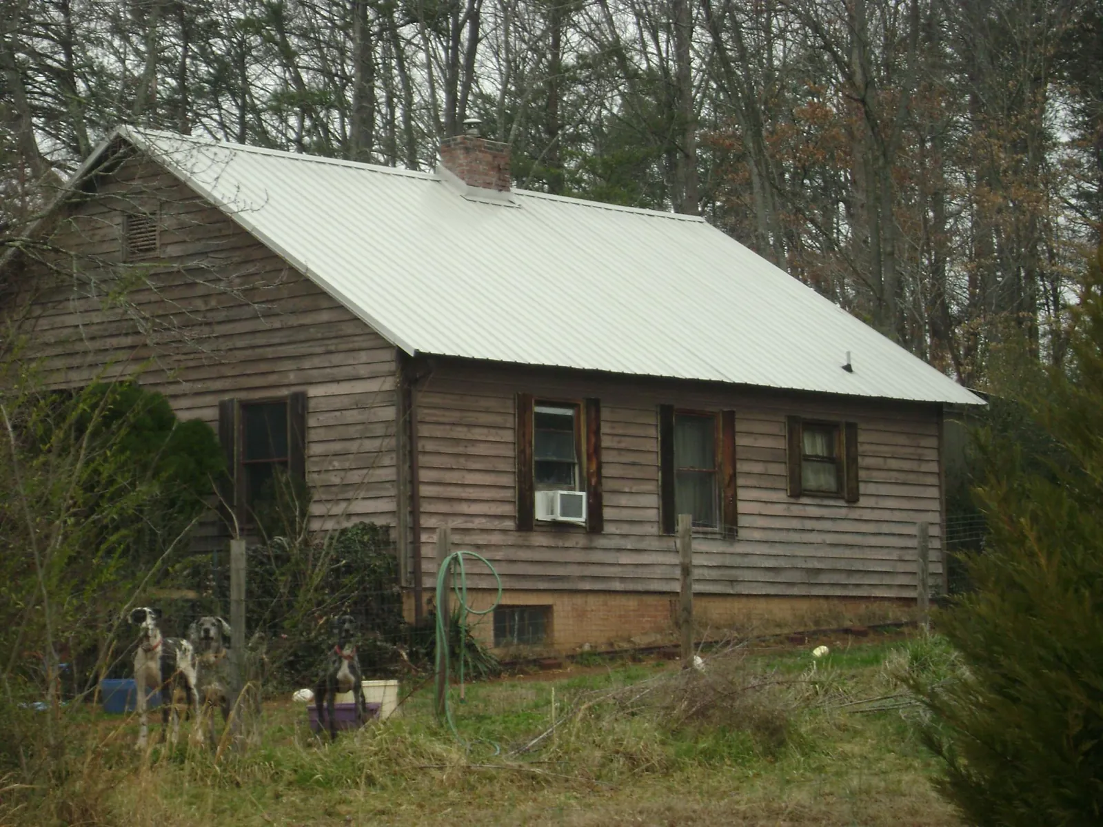 White metal roof on an old wood sided farmhouse, from a Metal Roof Installation job in Hedgesville